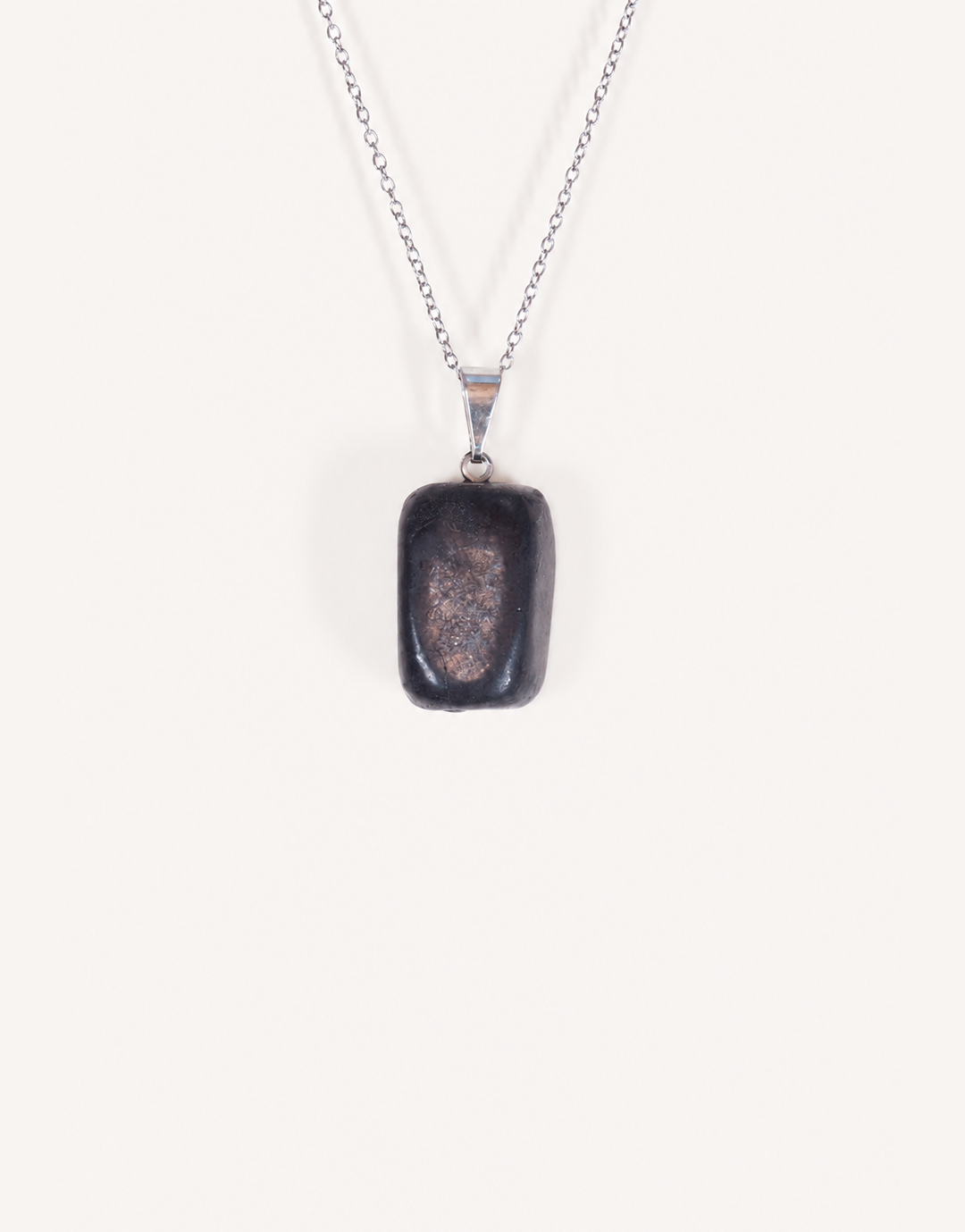 A Natural Shungite Pendant featuring a smooth graphite-black tumbled stone on an 18-inch stainless steel chain.