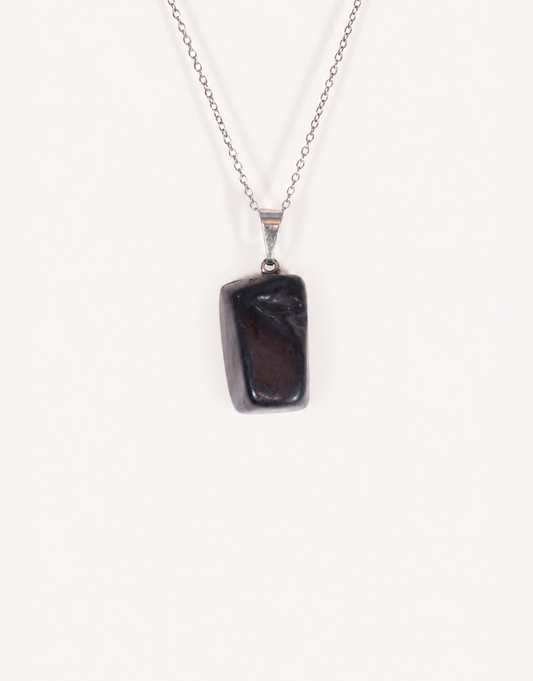 A Natural Shungite Pendant featuring a smooth graphite-black tumbled stone on an 18-inch stainless steel chain.