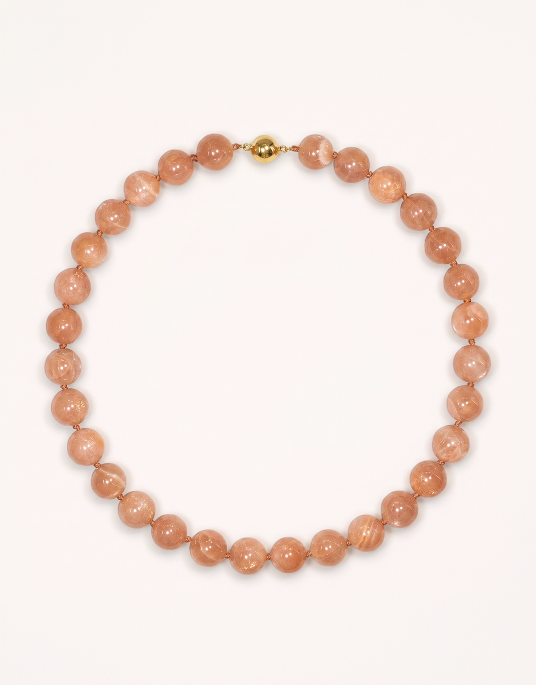 A 16-inch Natural Sunstone Choker crafted with polished 12mm beads in warm peach and terracotta tones with subtle metallic sparkle.