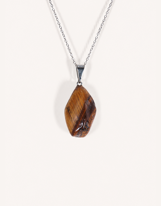 A Natural Freeform Tiger's Eye Pendant in a unique organic shape displaying golden-brown chatoyant shimmer on an 18-inch stainless steel chain.