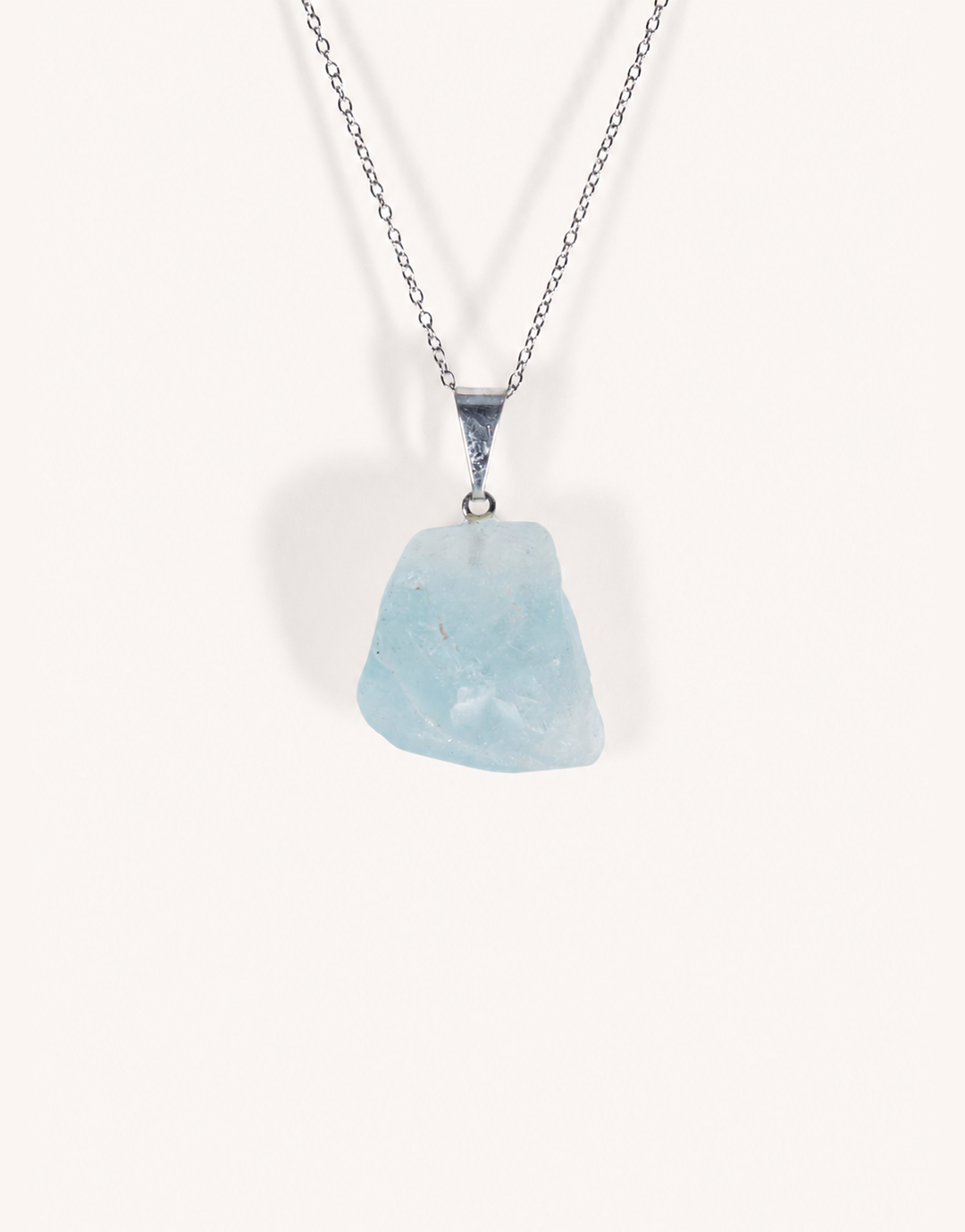 A Natural Blue Topaz Pendant displaying smooth sky-blue clarity on an 18-inch stainless steel chain.