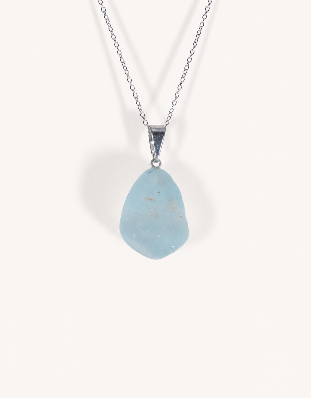 A Natural Blue Topaz Pendant displaying smooth sky-blue clarity on an 18-inch stainless steel chain.