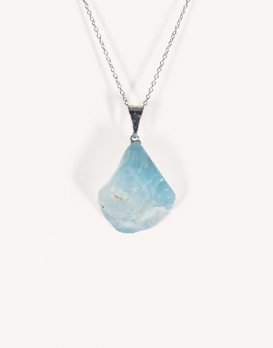 A Natural Blue Topaz Pendant displaying smooth sky-blue clarity on an 18-inch stainless steel chain.
