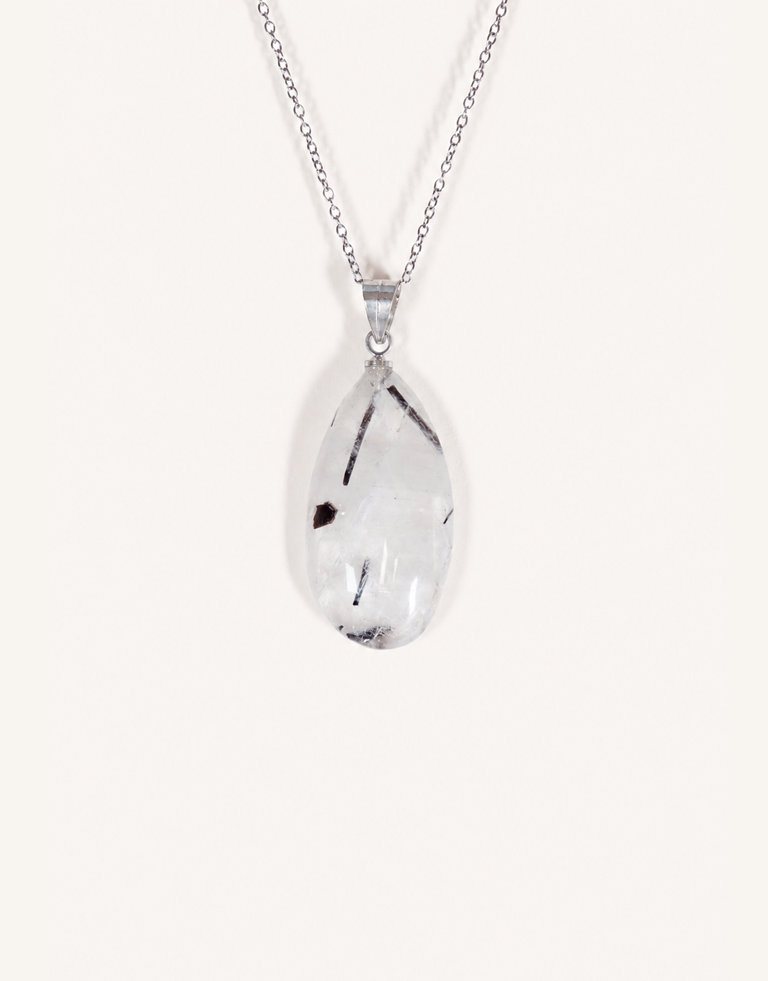A Natural Tourmalinated Quartz Pendant showcasing clear quartz with black tourmaline needle inclusions on an 18-inch stainless steel chain.