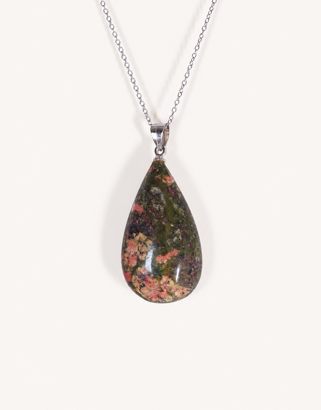 A Natural Unakite Pendant featuring a smooth green and coral-pink tumbled stone on an 18-inch stainless steel chain.