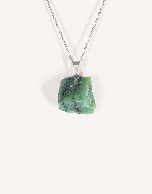 A Natural Raw Zoisite Pendant featuring a rough green crystal stone with black inclusions and a magenta ruby matrix spot on an 18-inch stainless steel chain.